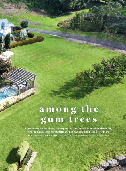 Lush green lawn with a pool and garden area, featuring text 'among the gum trees'.
