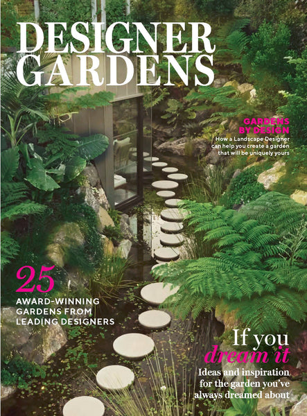 Magazine cover titled 'Designer Gardens' with a garden surrounded by a pond, with stepping stones. Writing on the page with award winning gardens. 